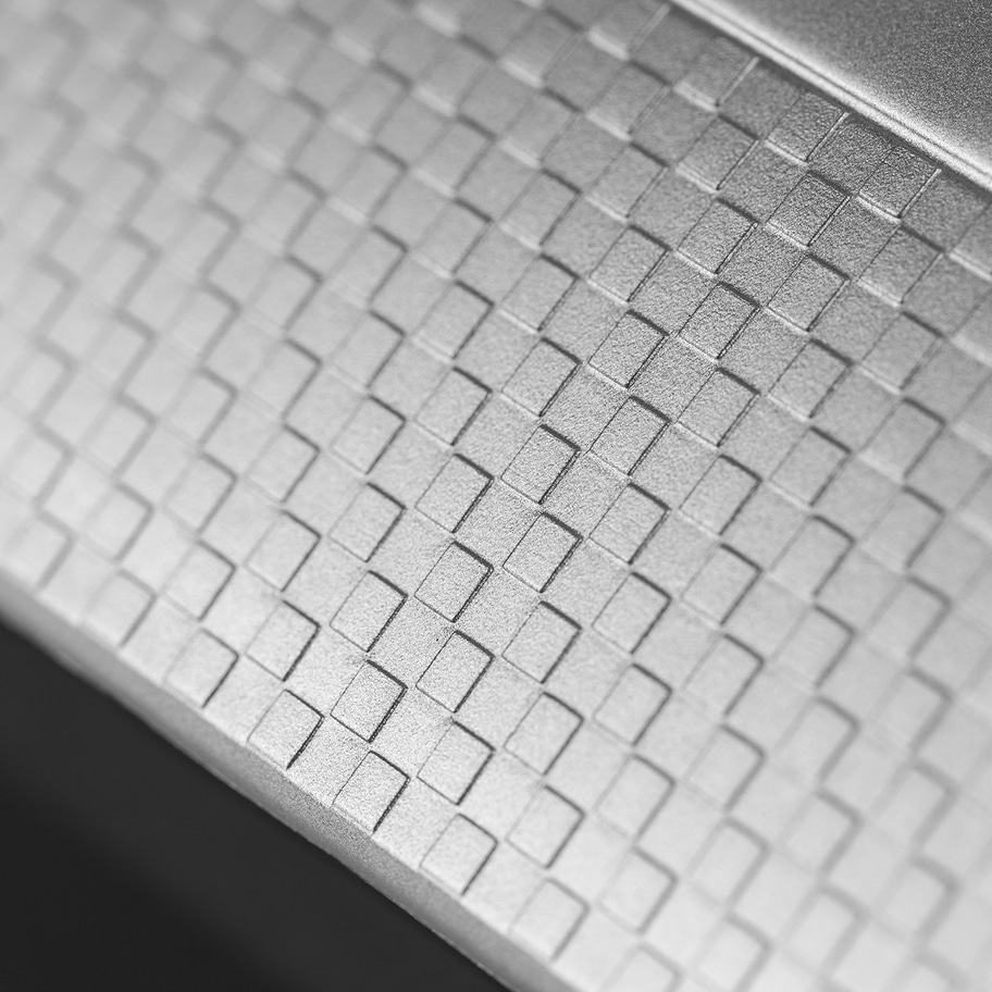 Nahaufnahme einer grauen Oberfläche mit quadratischem Muster, Textur